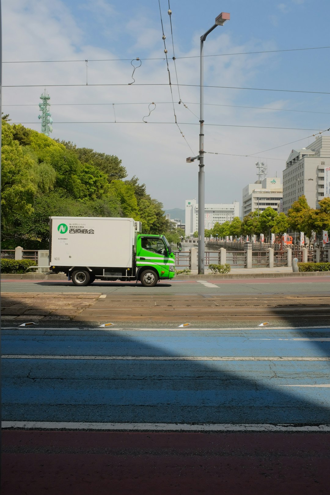 white and green truck on road during daytime