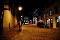 A quiet street scene at dusk, with soft glowing lanterns and cobblestone paths.