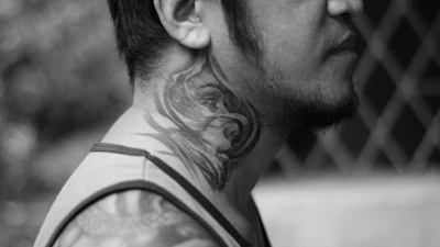 Artistic black and grey portrait tattoo on the shoulder blade.