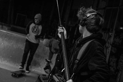 Behind-the-scenes view of a boom operator capturing audio on a bustling film set.