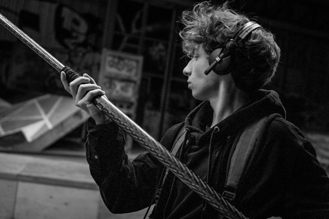 Audio interface and headphones connected to a recording setup showing monitoring chain in a post-production environment