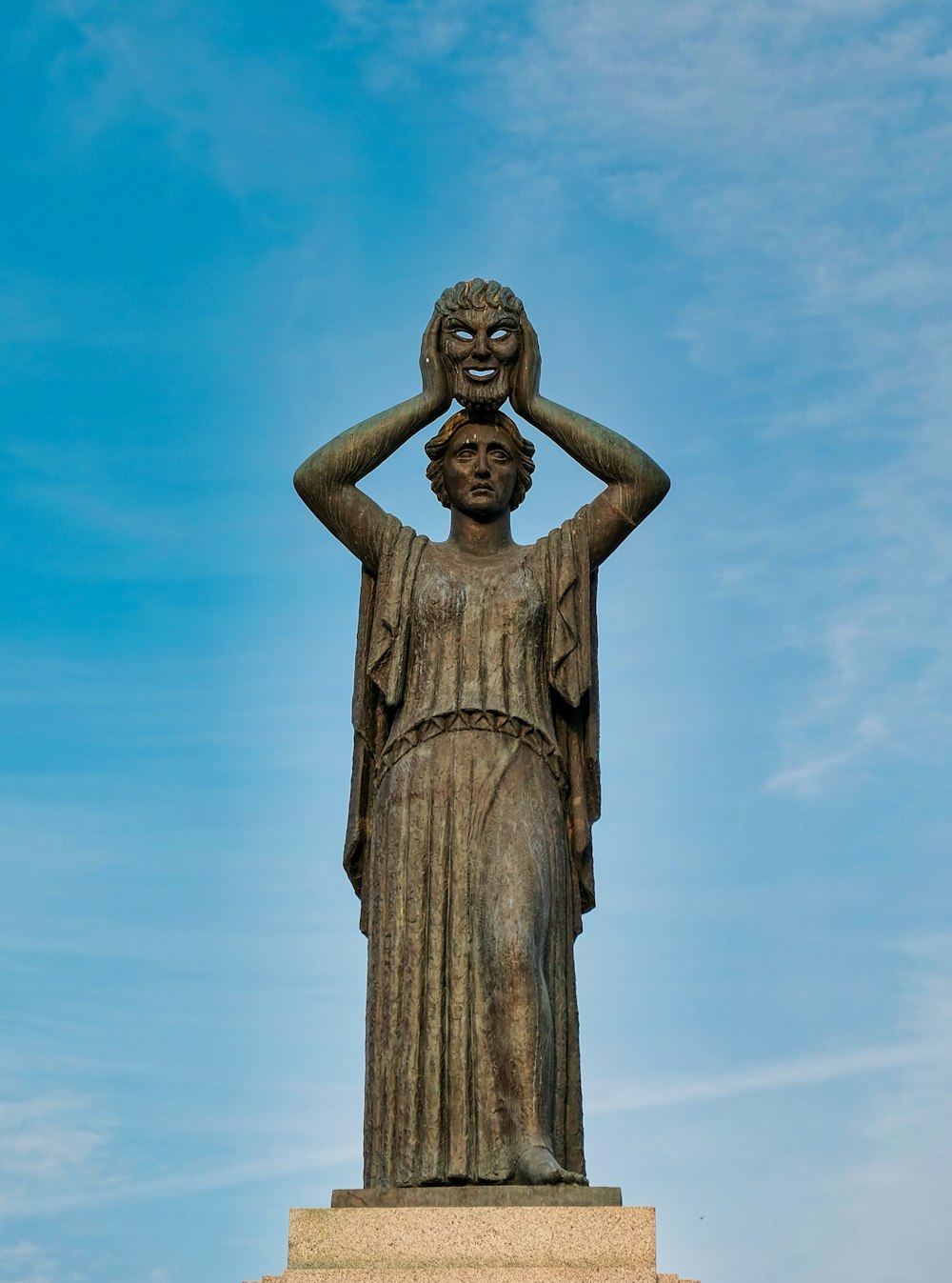 brown concrete statue under blue sky during daytime