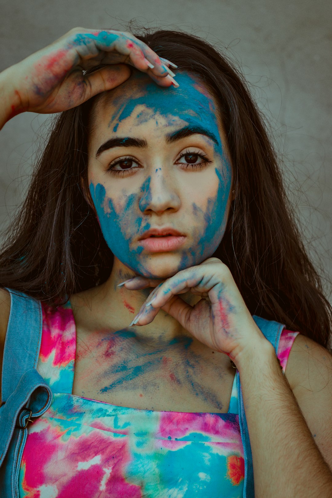 woman in pink and blue tank top with blue face paint