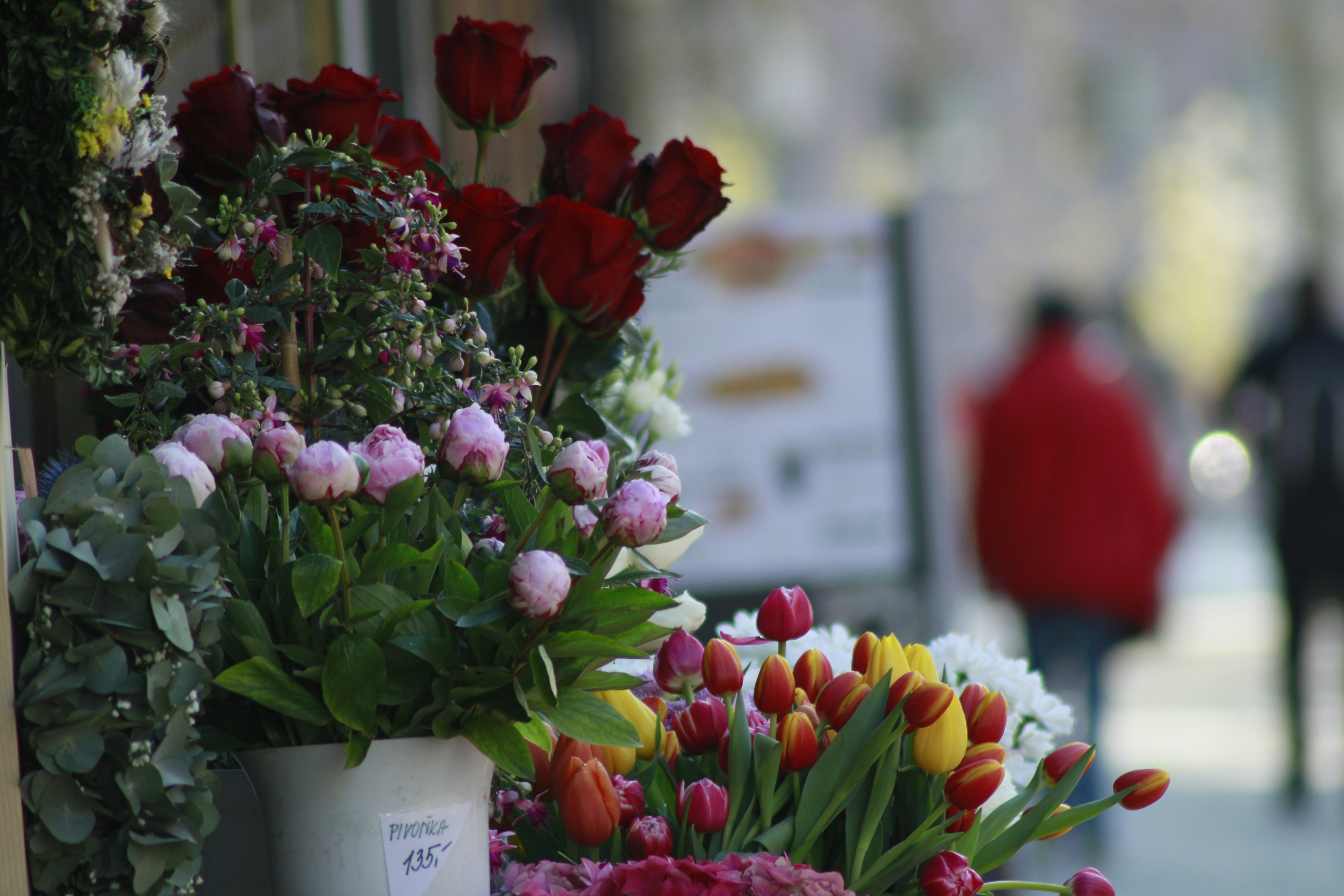 red and yellow flowers in white ceramic vase