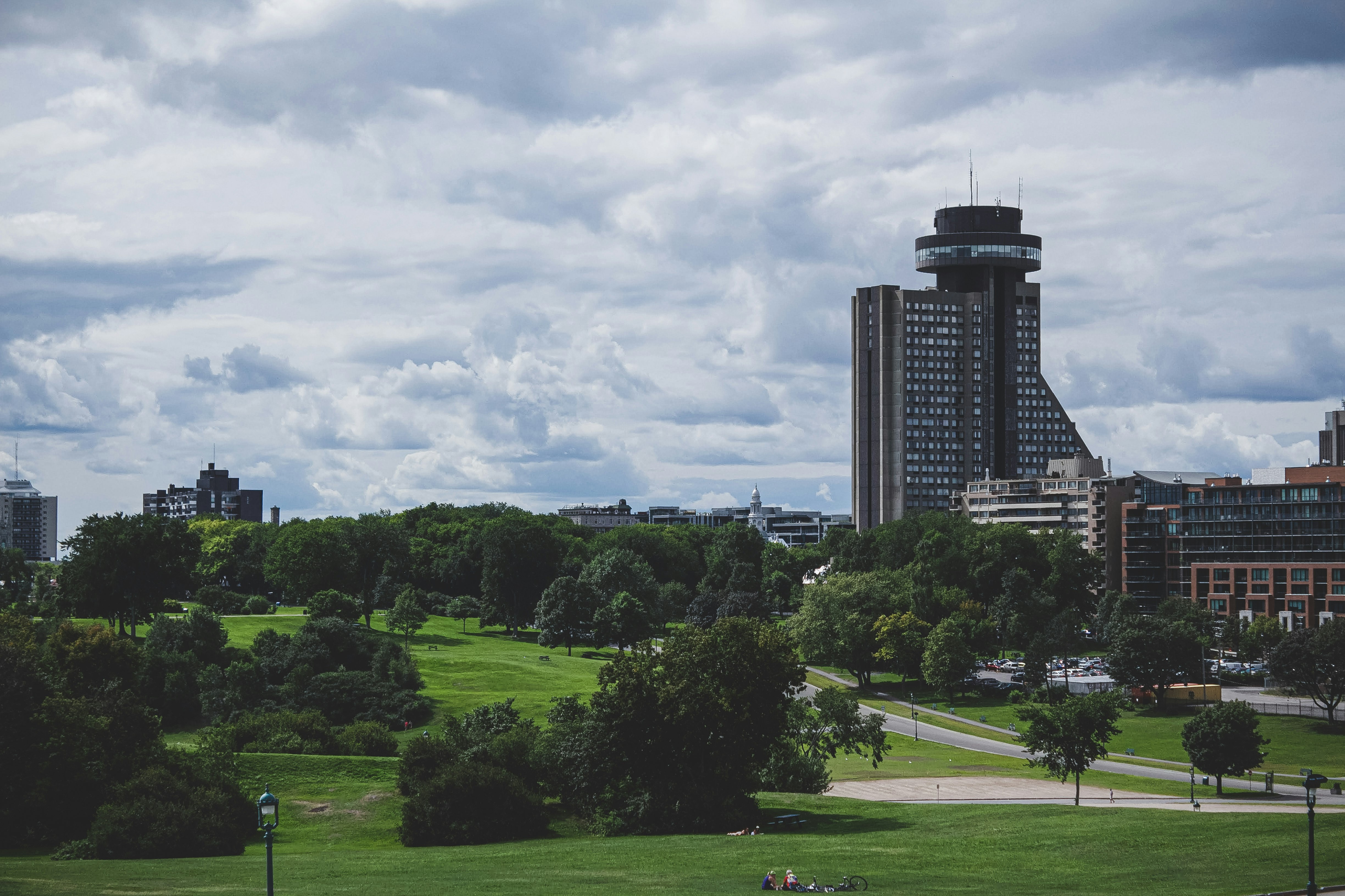 green grass field near high rise building during daytime