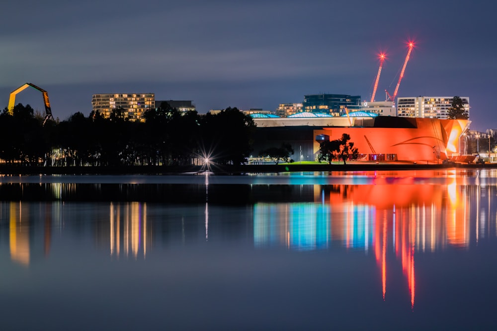 red and white ship on water during night time