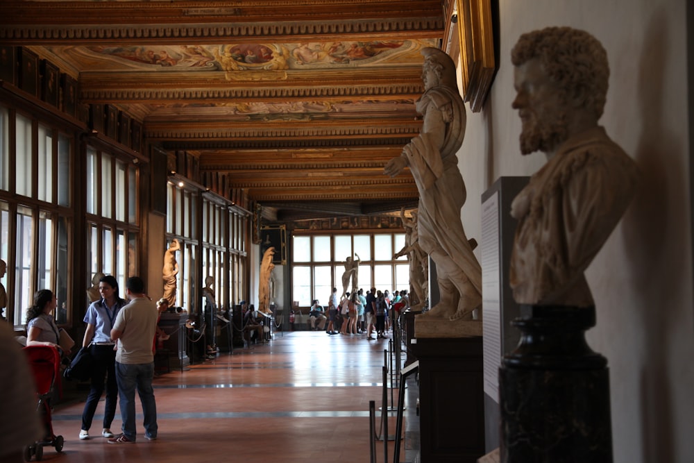 people walking on brown wooden floor