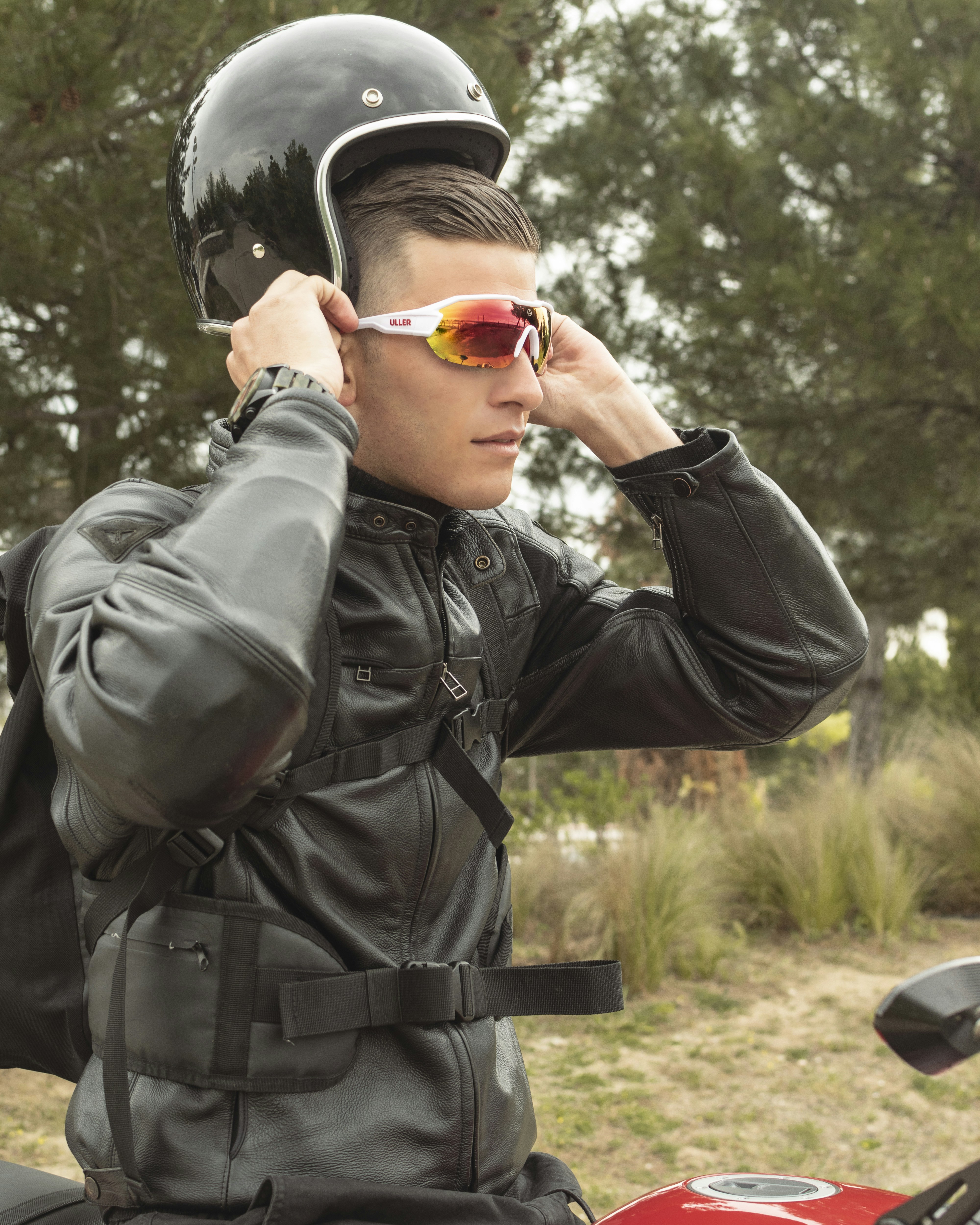 man in black leather jacket wearing orange sunglasses