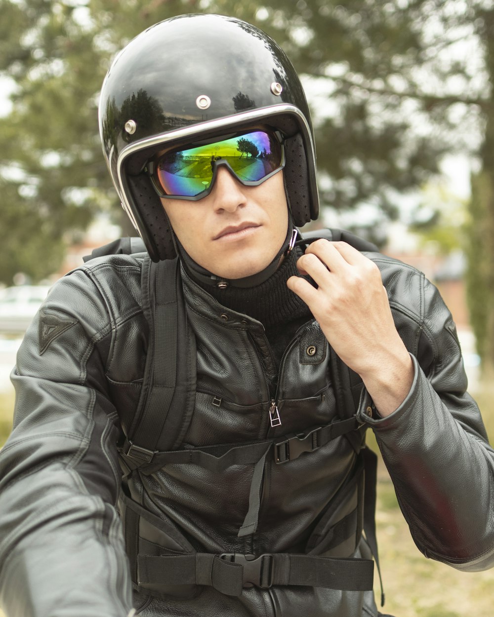 man in black leather jacket wearing blue and black helmet