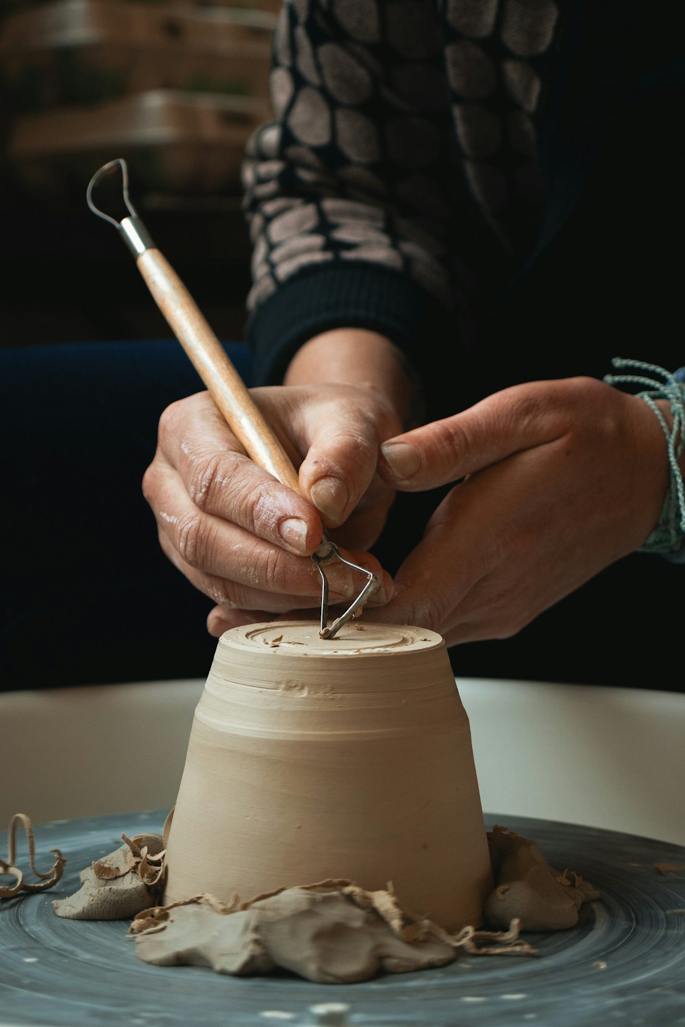 person holding white plastic cup with brown liquid