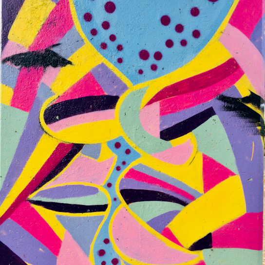 A vibrant street mural showcasing colorful abstract shapes and urban art style.