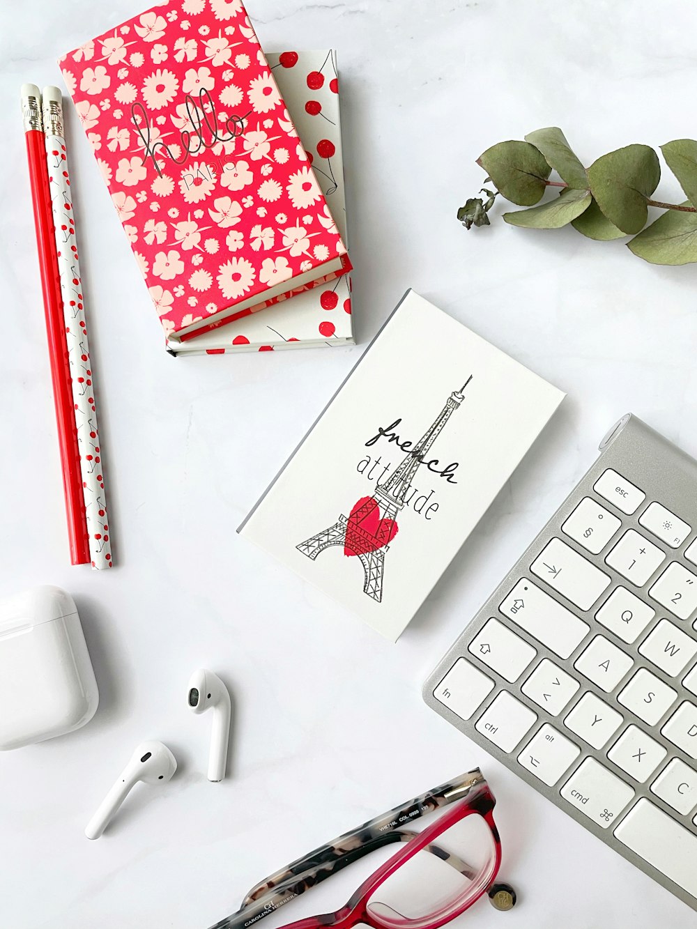 white and red heart card beside white computer keyboard