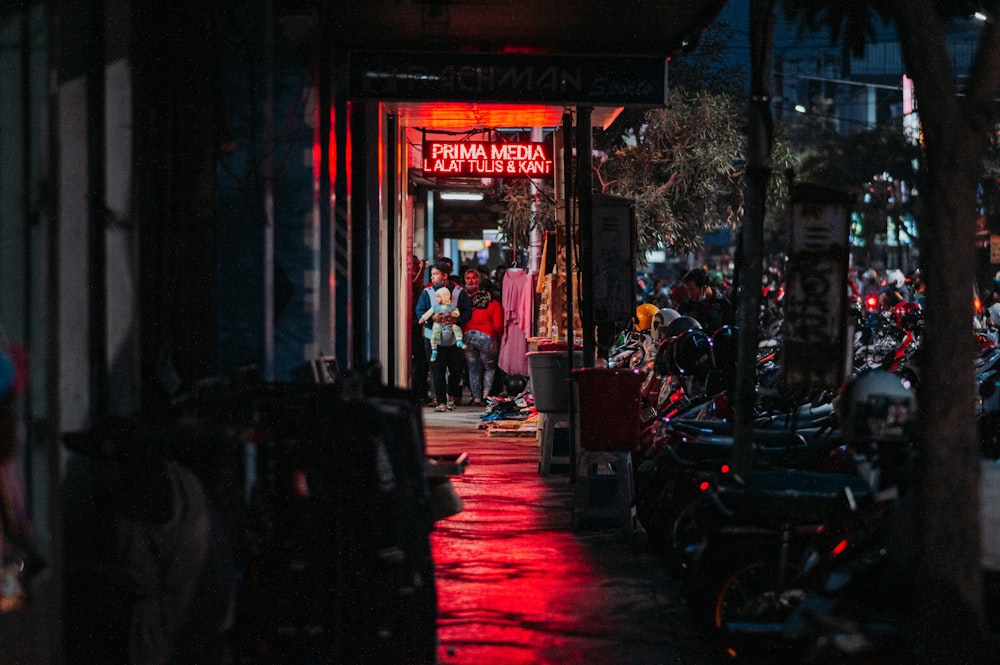 people sitting on chair near store during night time