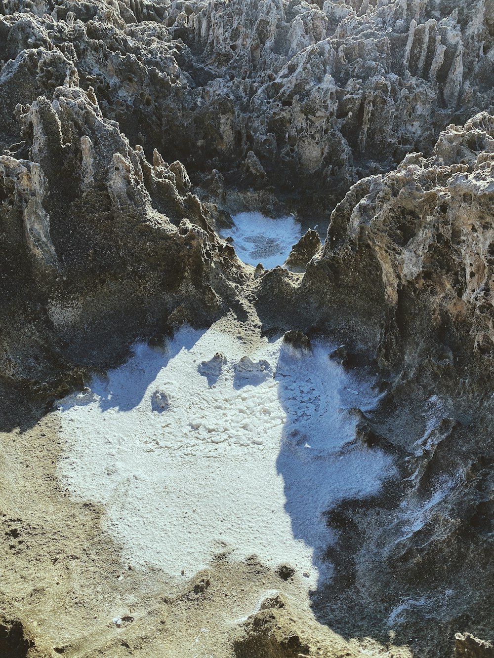 white snow on gray sand