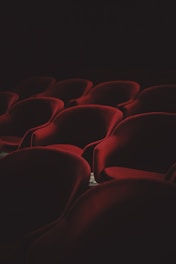 A cozy theater setting with plush seats and a softly glowing stage, ready for a live performance.