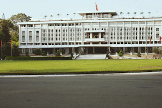 white concrete building near green grass field during daytime