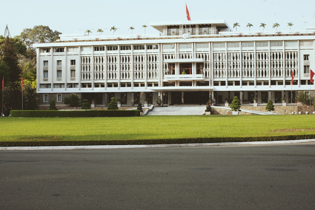 white concrete building near green grass field during daytime