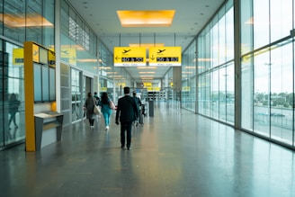 man in black jacket walking on hallway