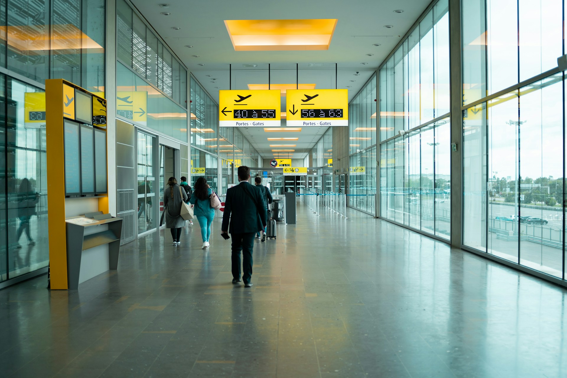 man in black jacket walking on hallway