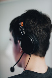 man wearing black headphones and black headphones