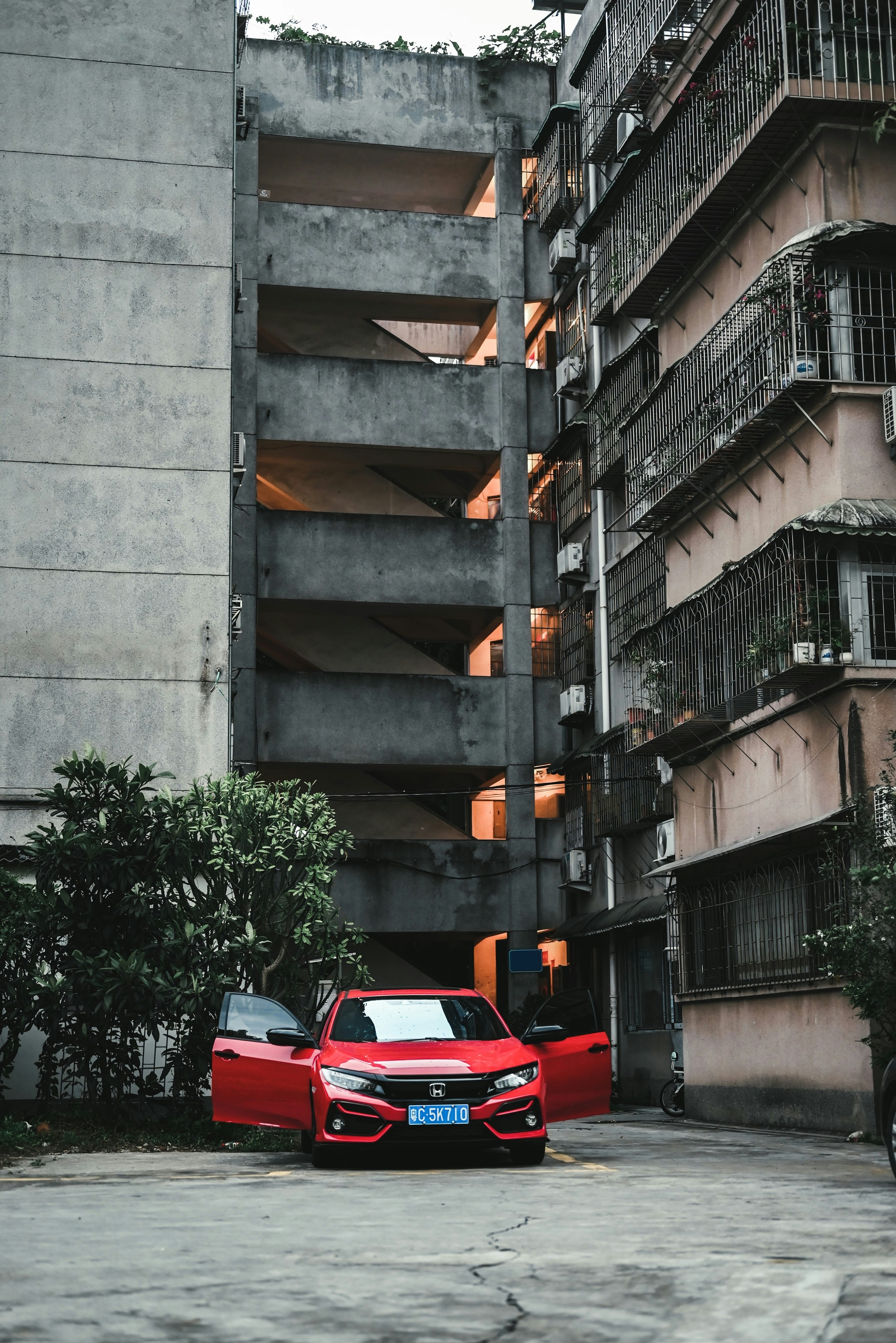 red car parked beside building