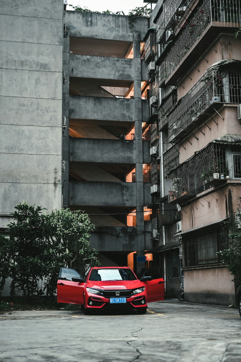 red car parked beside building