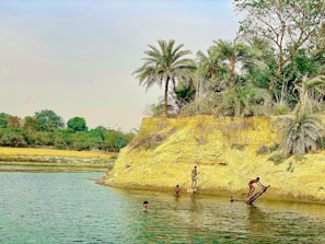 Students conducting environmental tests near a riverbank