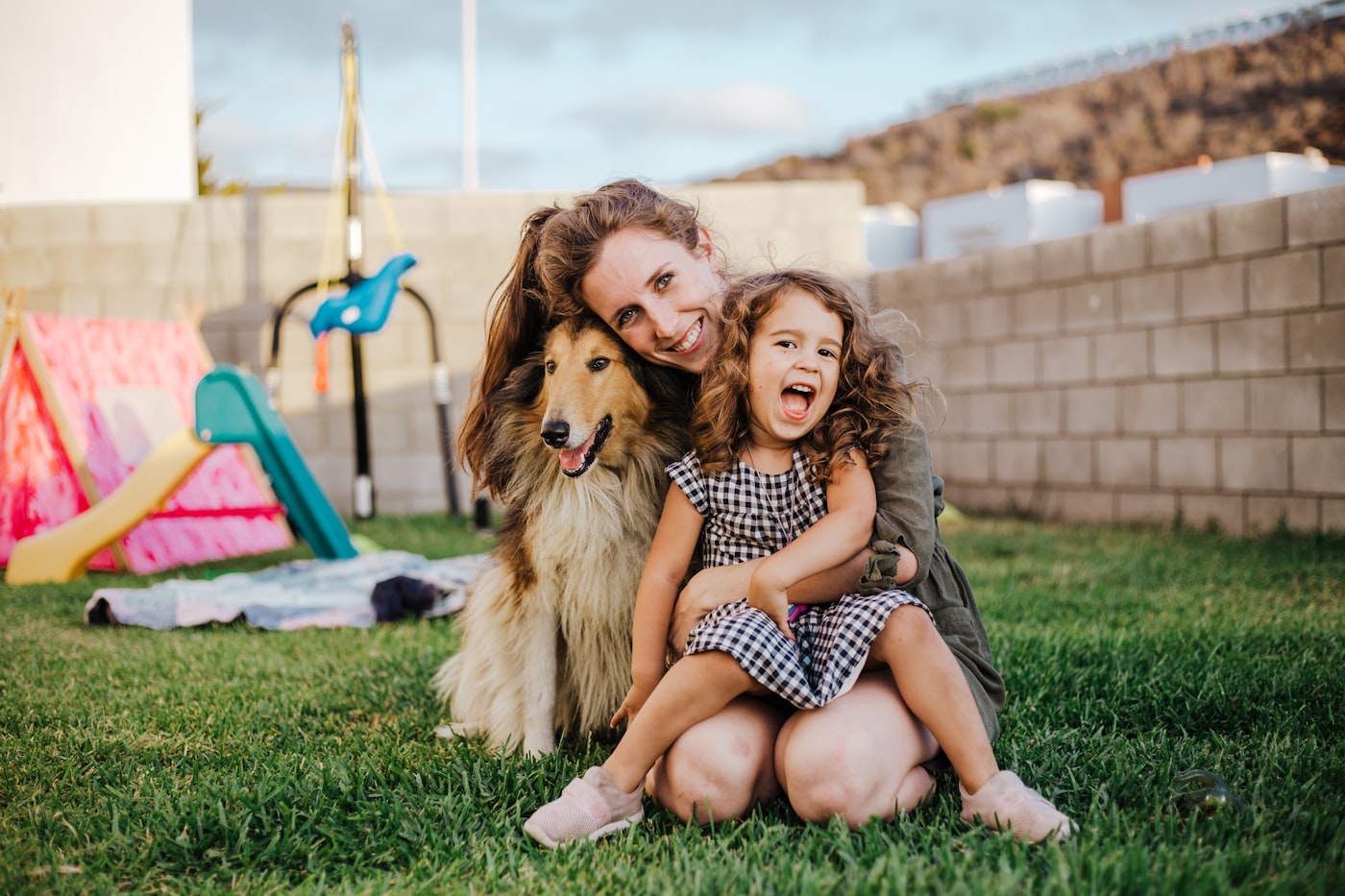A parent and child with their dog