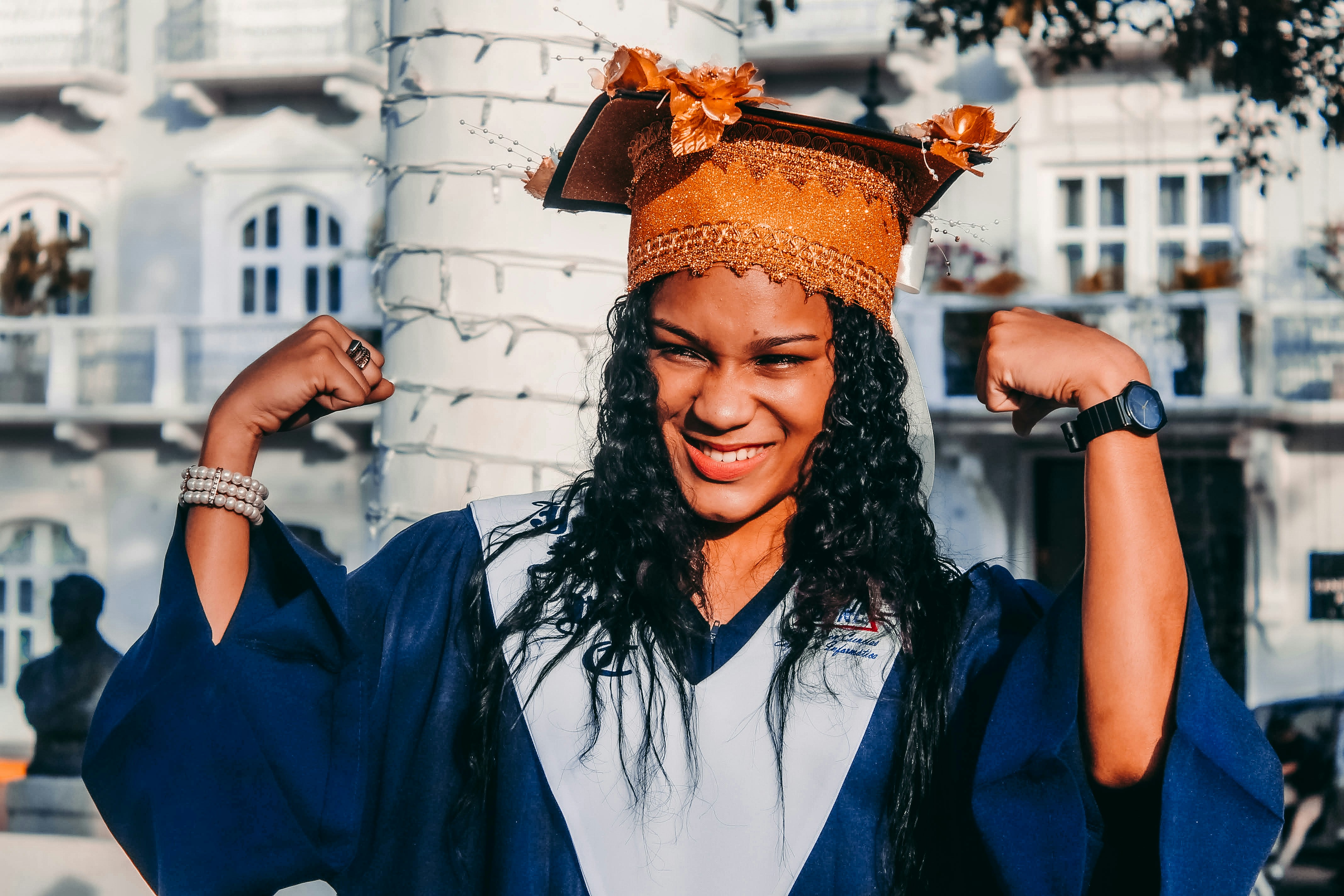 woman in blue long sleeve shirt wearing gold crown