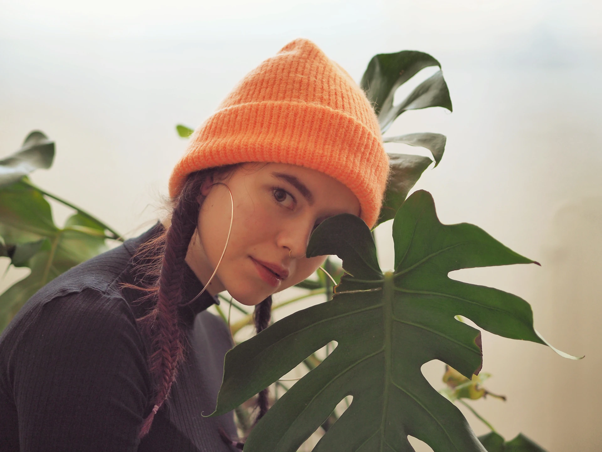 woman in black jacket and orange knit cap
