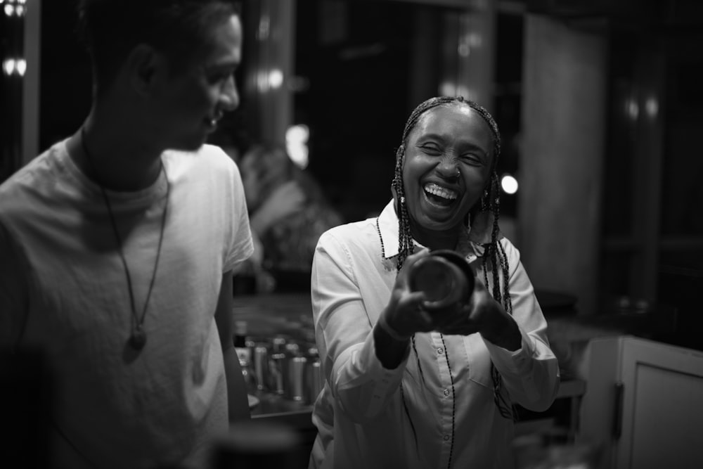 grayscale photo of man and woman smiling