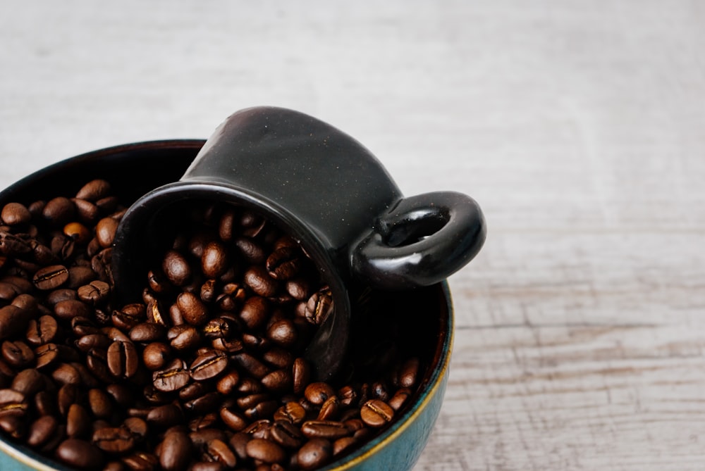coffee beans in blue ceramic mug