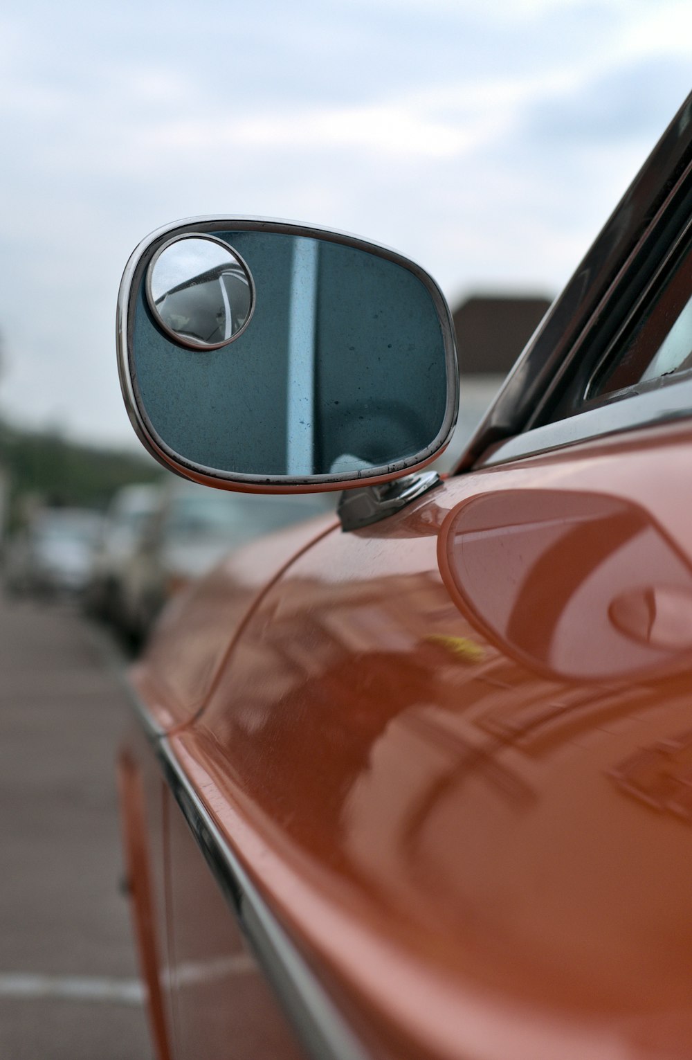 red car with side mirror