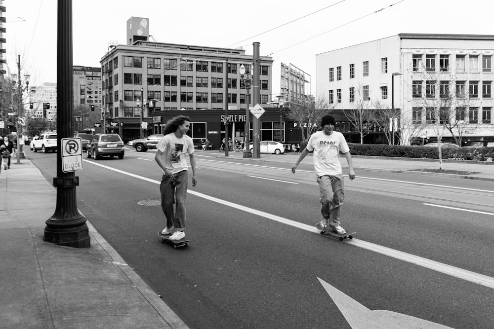 grayscale photo of man and woman walking on the street