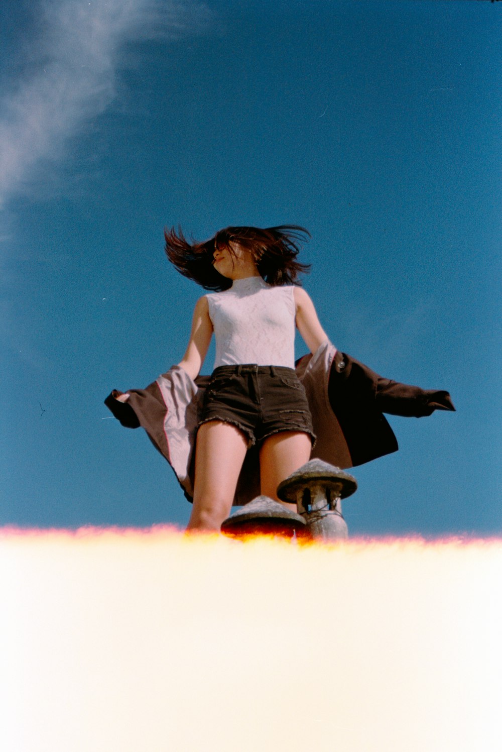 a woman standing on top of a skateboard