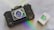 A vintage camera with a prominent lens and detailed body design is positioned on a smooth surface. Beside it is a box of Ilford HP5 Plus 400 black and white film. A subtle rainbow reflection adds a touch of color to the scene.