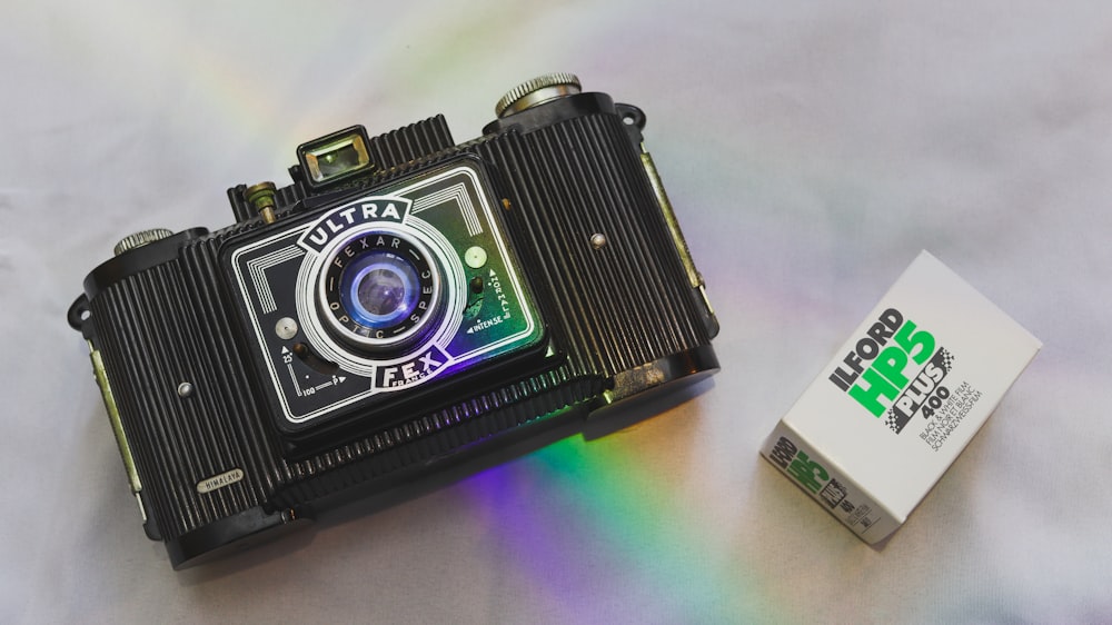 black and silver camera on white table