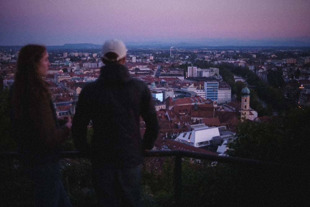 man in black jacket standing on top of building during daytime