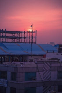 Technicians installing fiber optic cables in a modern urban neighborhood at sunset