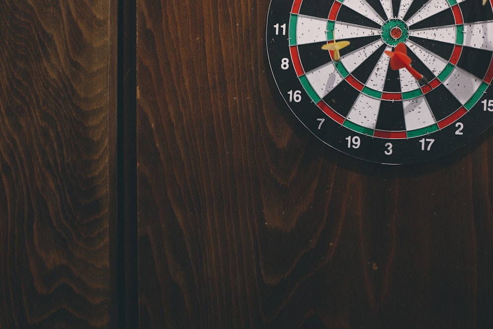 black white red and green round analog clock