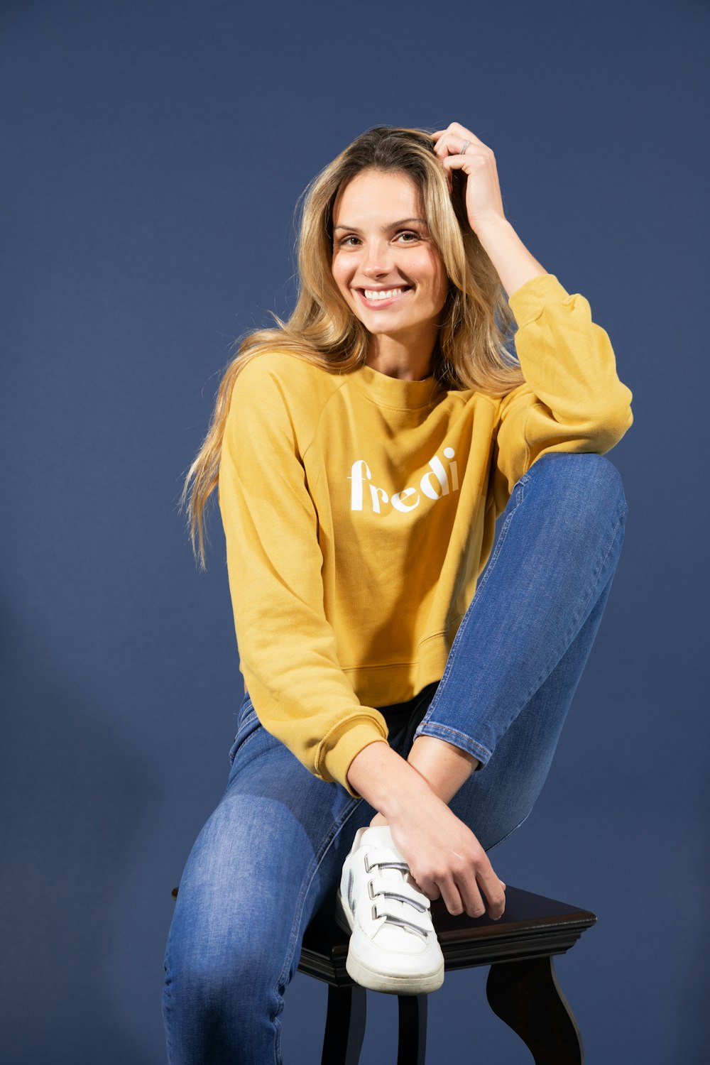 woman in yellow long sleeve shirt and blue denim jeans