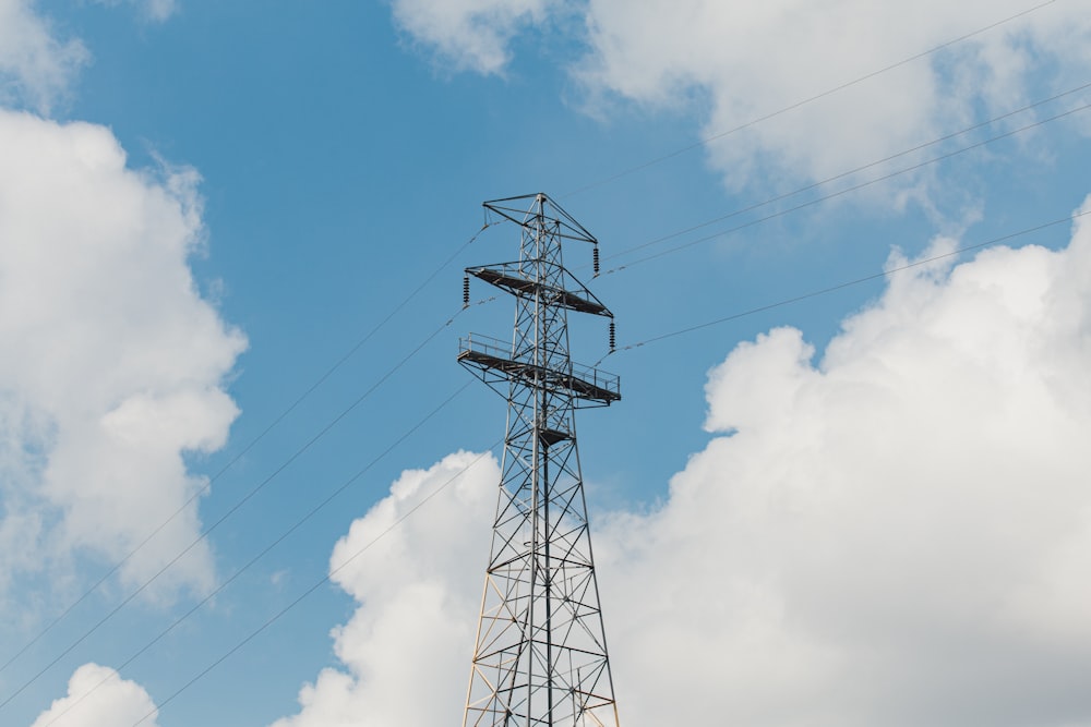 black metal tower under blue sky and white clouds during daytime