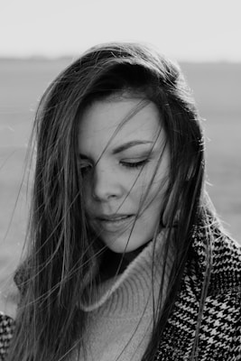 grayscale photo of woman in knit sweater