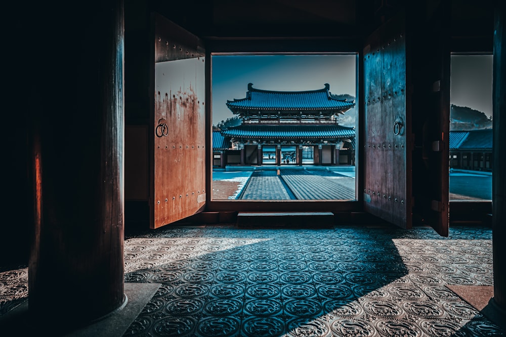 brown wooden door with blue and white carpet