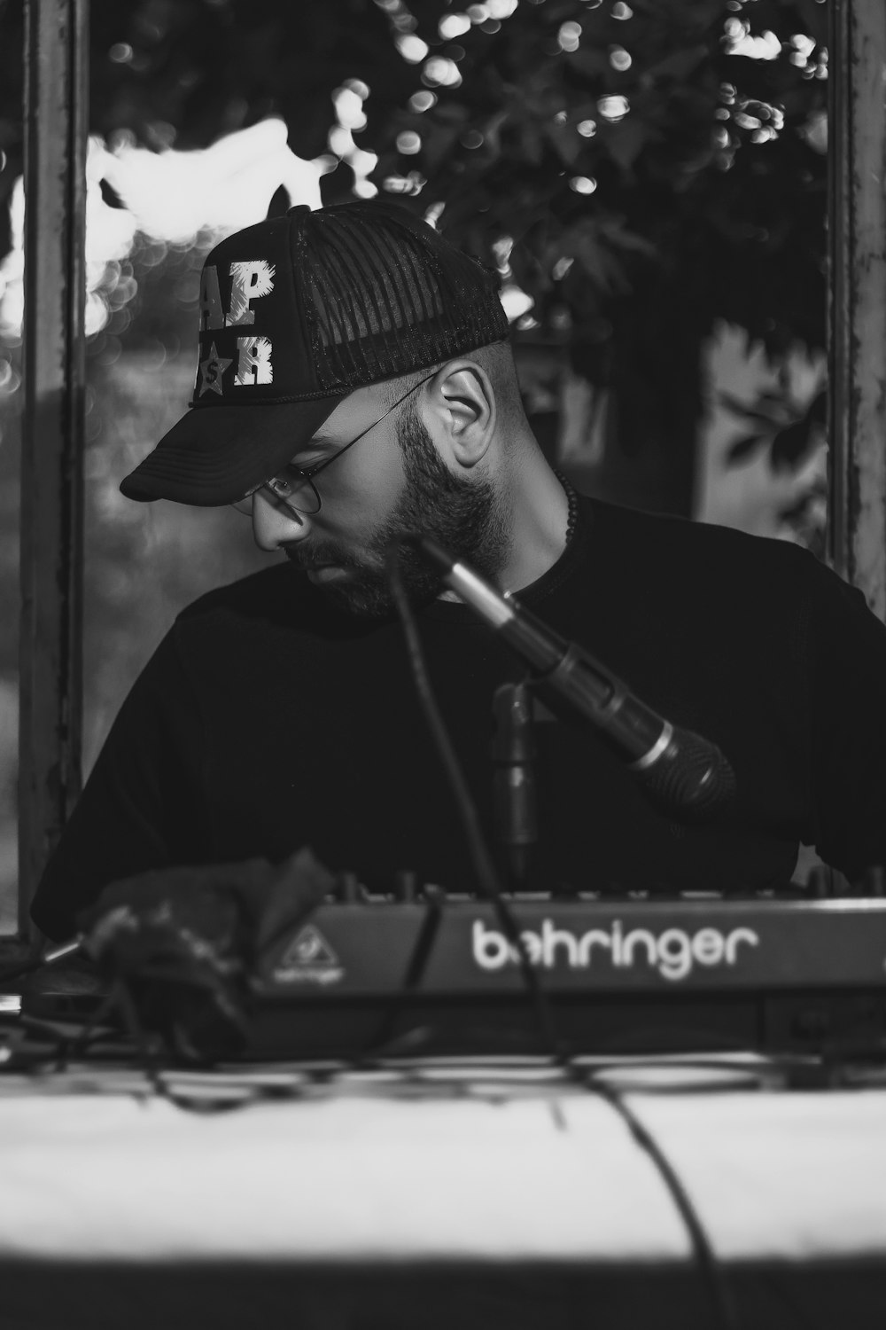 man in black hat playing piano