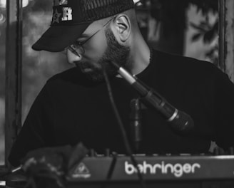 man in black hat playing piano