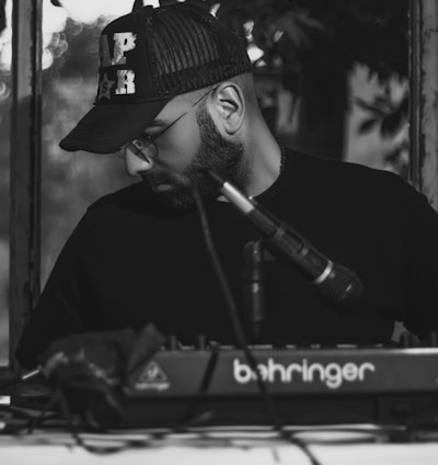 man in black hat playing piano