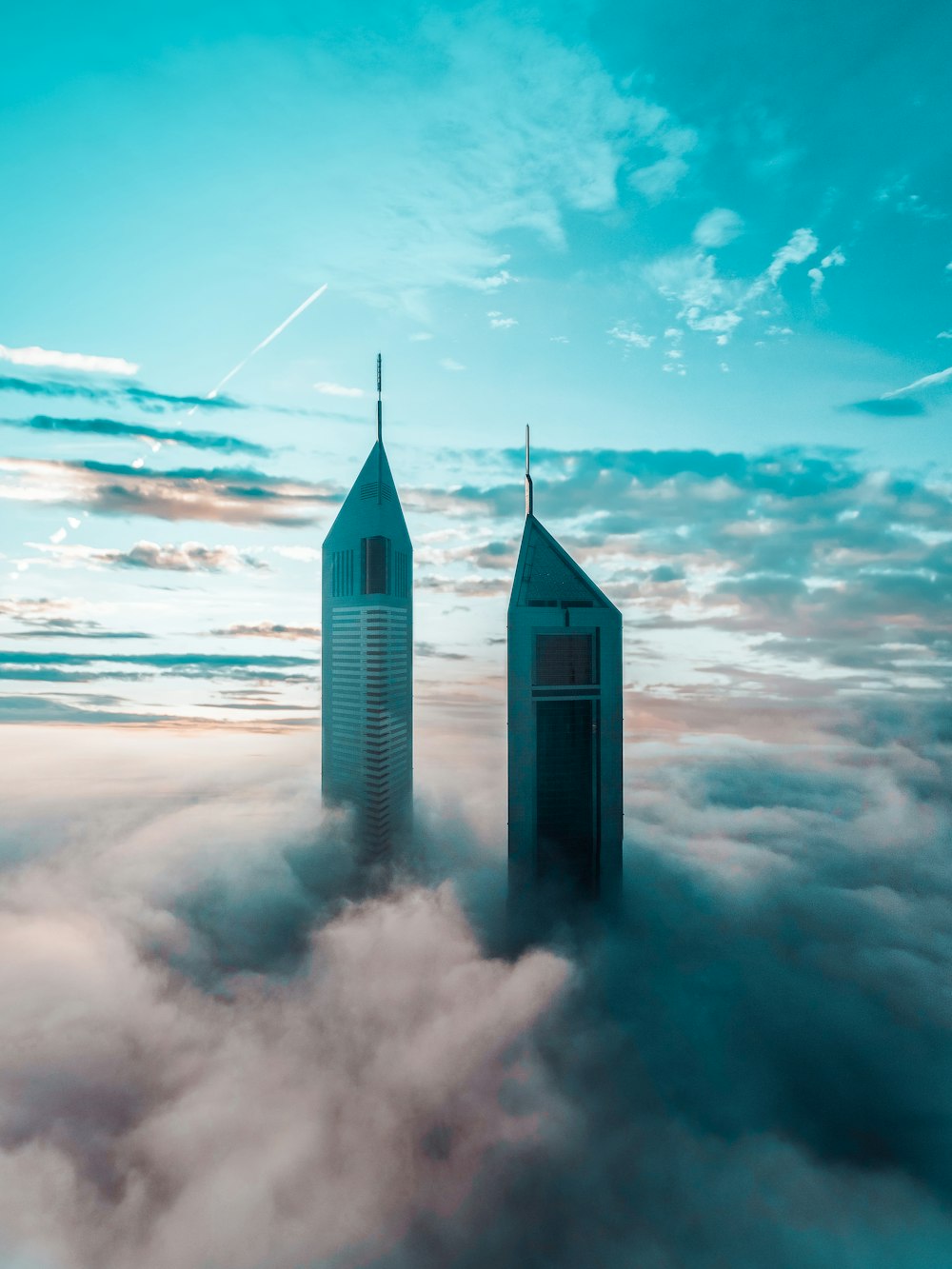 gray concrete building on white clouds during daytime