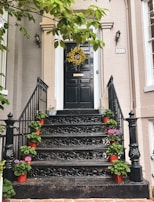 An inviting entryway adorned with a handmade black and yellow wreath.