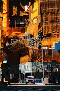 Construction site with scaffolding and safety signs.